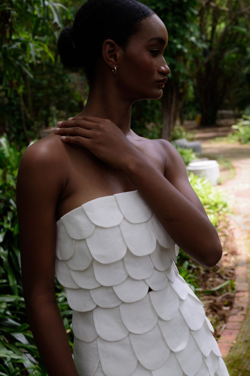 Ivory Petalia crop top by ANA + MARIA featuring a fitted design and sleeveless style, shown on a model.