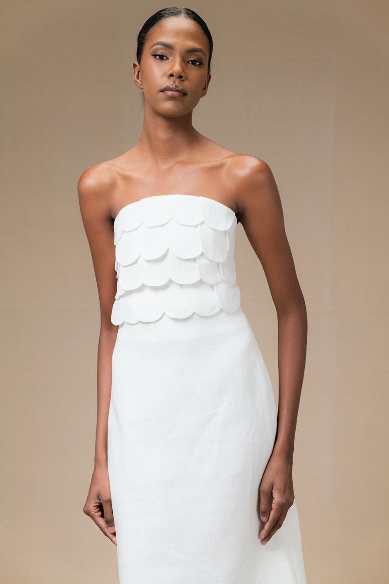 Ivory Petalia crop top by ANA + MARIA displayed on a model, featuring a fitted design and short sleeves.