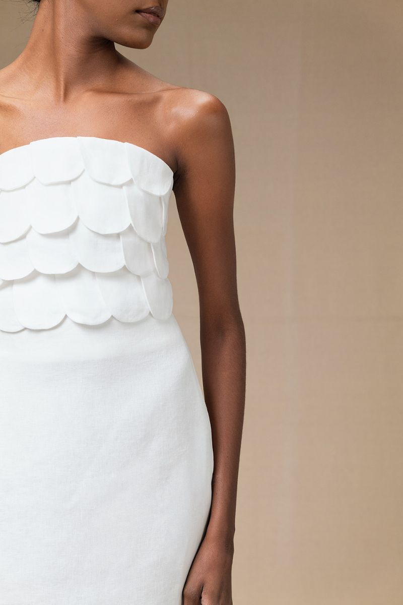 Ivory Petalia crop top by ANA + MARIA, featuring a fitted design and sleeveless style, displayed on a flat lay.