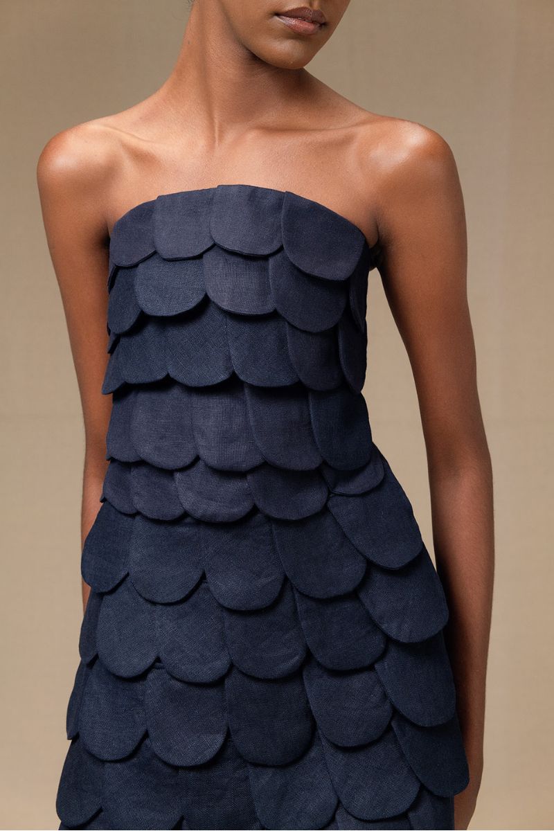 Navy blue Petalia mini skirt by ANA + MARIA, displayed on a model with a fitted waist and A-line silhouette.
