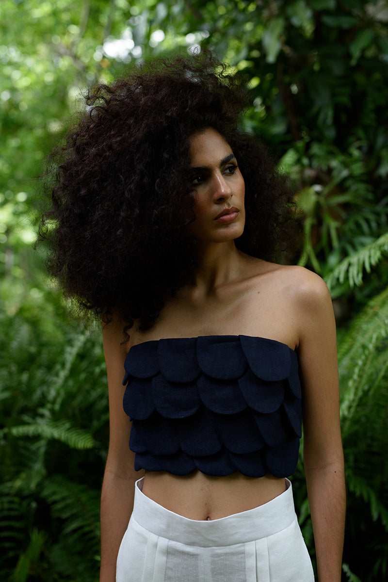 Navy blue Petalia crop top by ANA + MARIA shown on a model, featuring a fitted design and short sleeves.