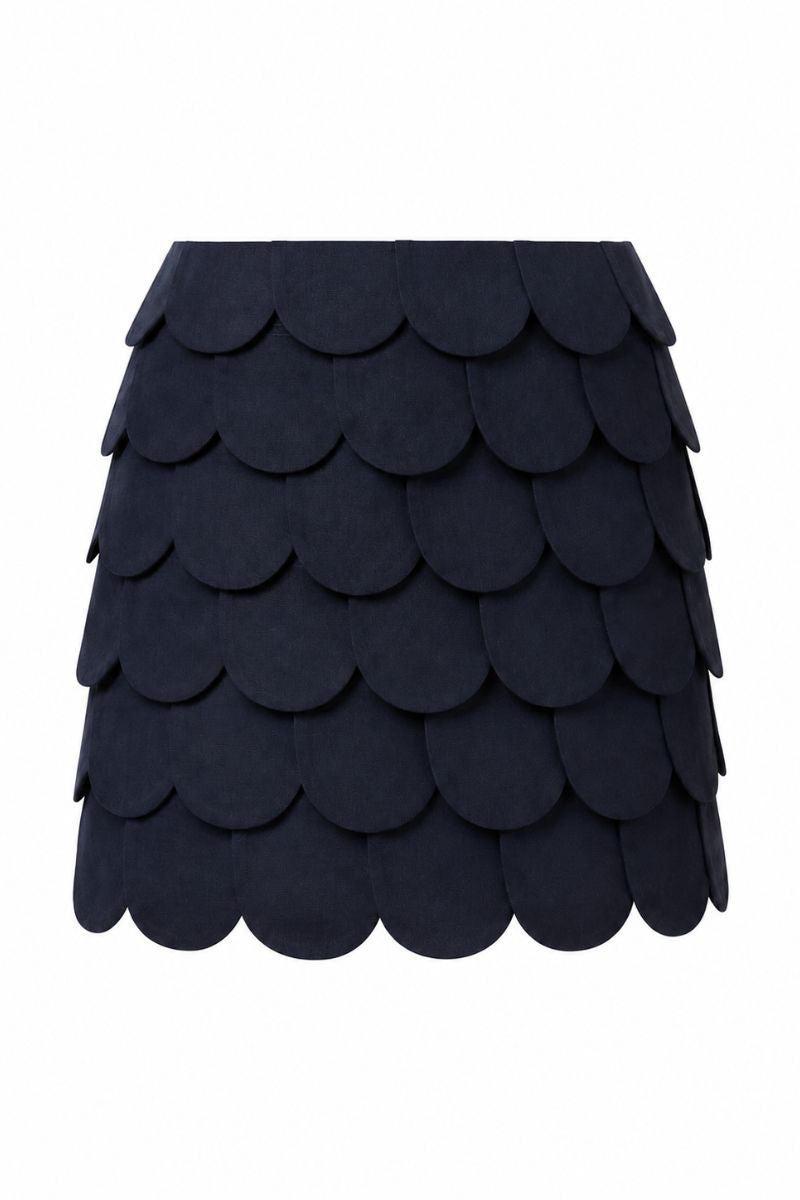 Navy blue Petalia mini skirt by ANA + MARIA displayed on a mannequin with a crop top for a stylish look.
