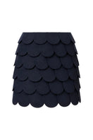 Navy blue Petalia mini skirt by Ana + Maria displayed on a ghost mannequin, showcasing the fitted style and fabric texture.
