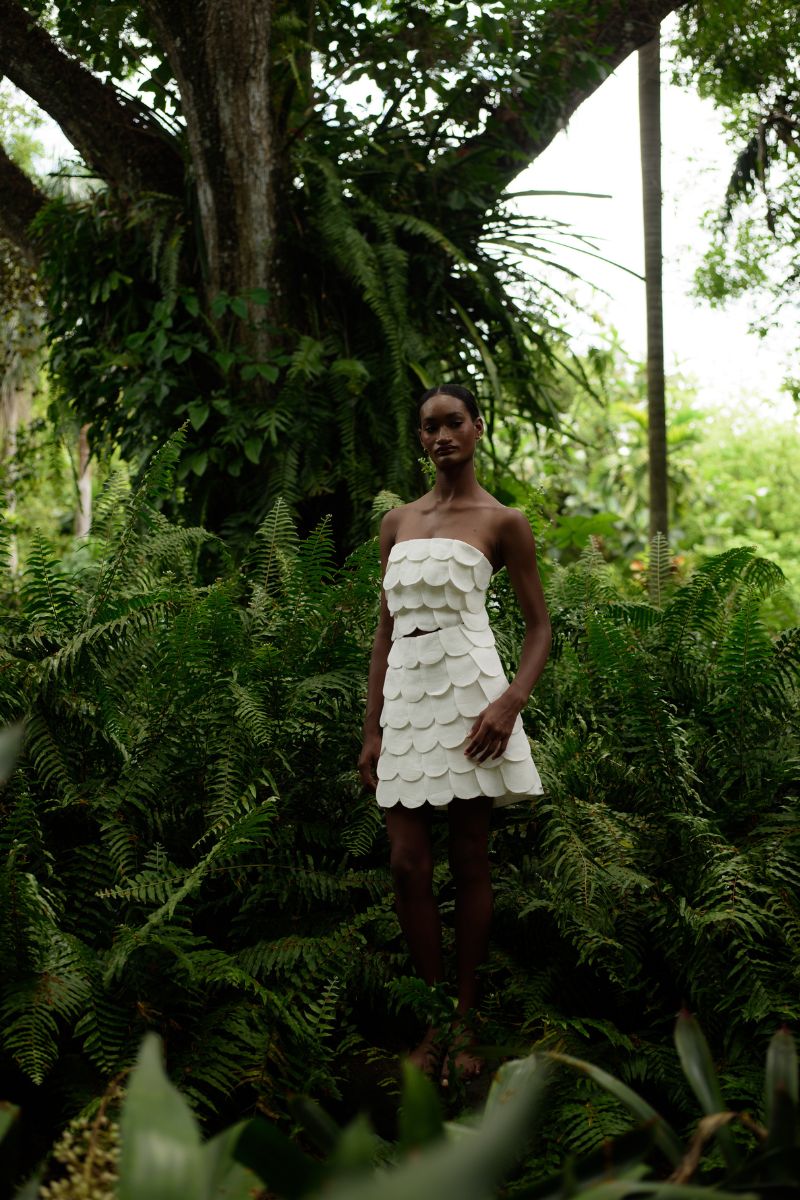 Ivory Petalia mini skirt by ANA + MARIA, shown in a campaign photo with a fitted waist and stylish design.