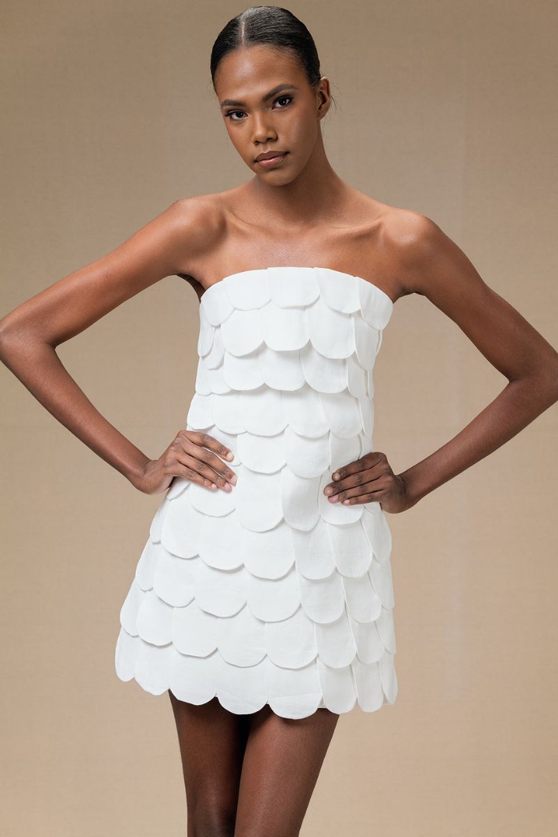 Ivory Petalia mini skirt by ANA + MARIA, shown on a model, featuring a stylish, fitted design with a smooth fabric finish.