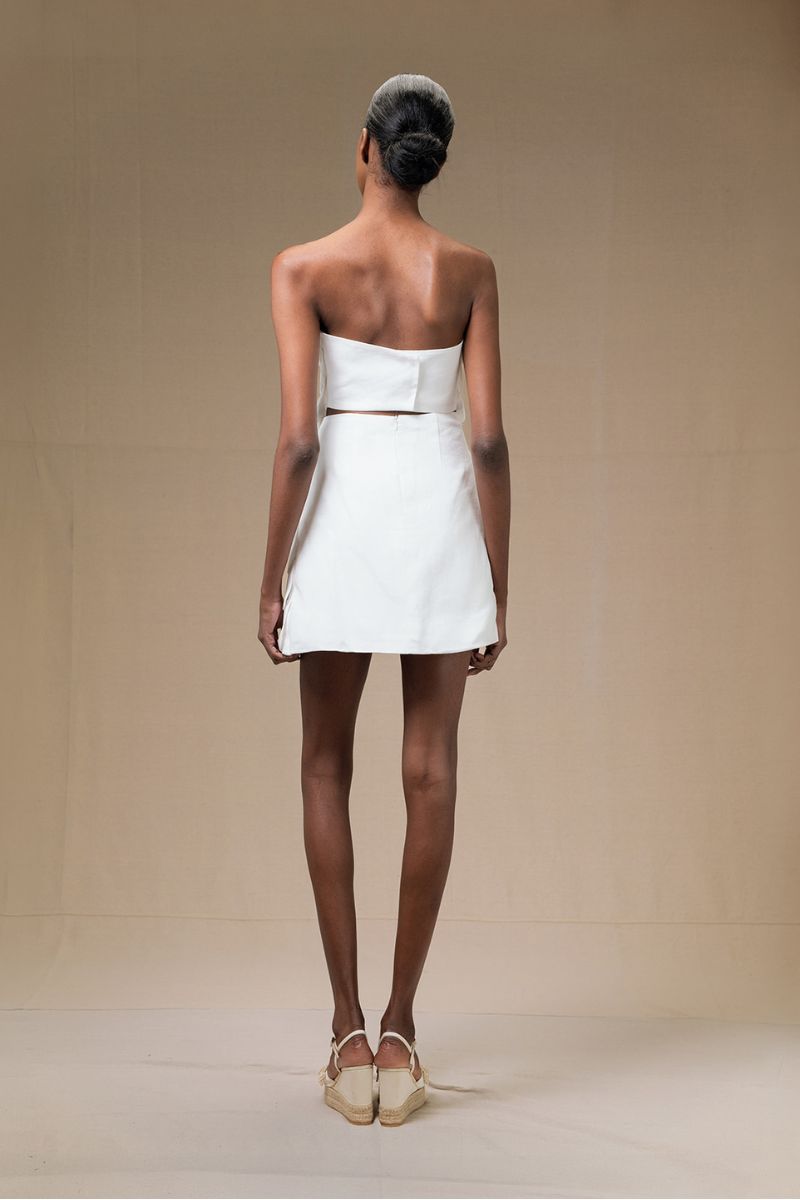 Ivory Petalia mini skirt by ANA + MARIA, featuring a stylish, fitted design with a smooth fabric finish.