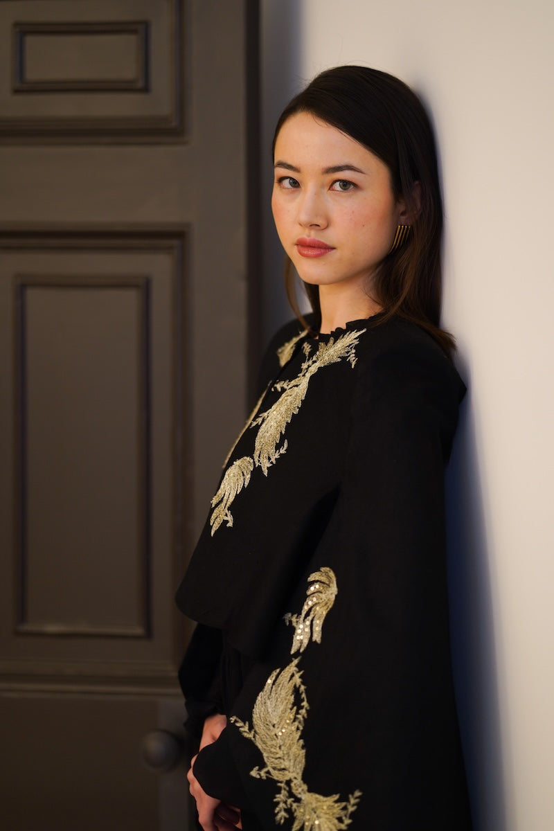 Nadya Shah Phoebe Cape jacket shown, lightweight outerwear with a flowing design, perfect for stylish layered looks.
