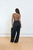 Back view of YASSMIN SALEH black pinched pants showing tailored waistband and fitted style.
