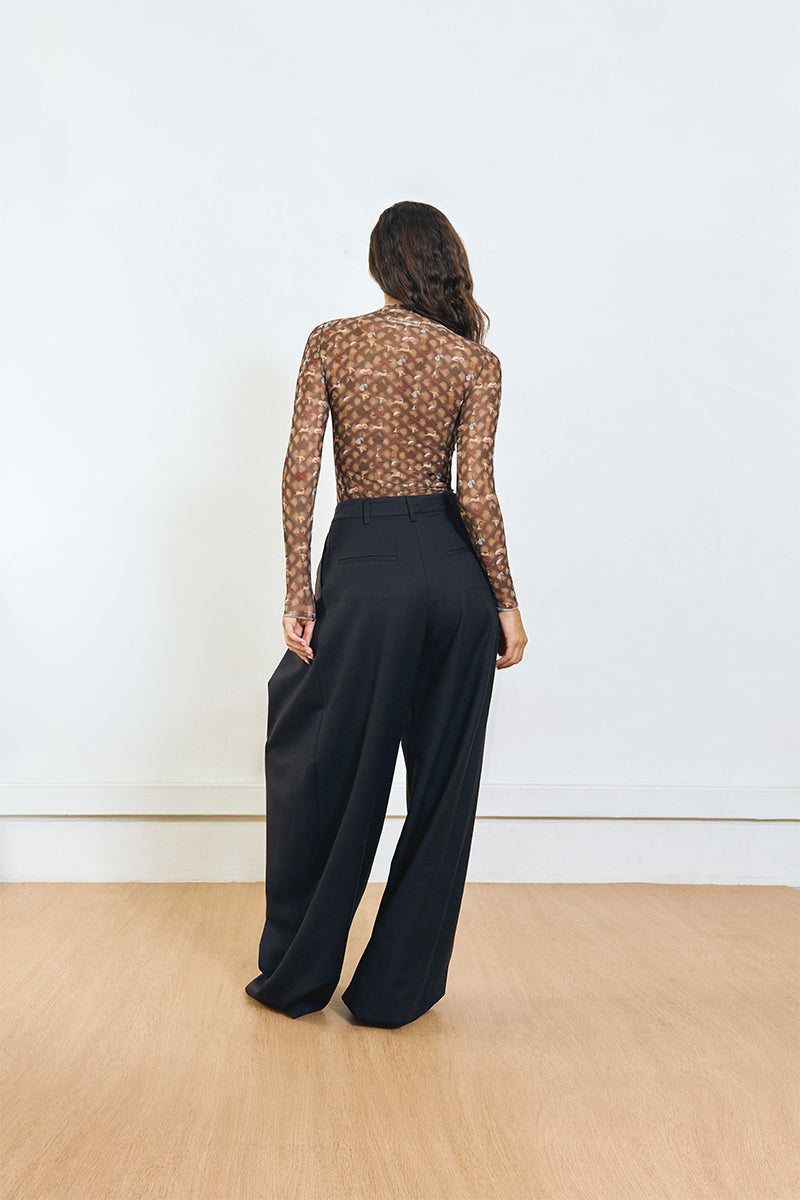Back view of YASSMIN SALEH black pinched pants showing tailored waistband and fitted style.