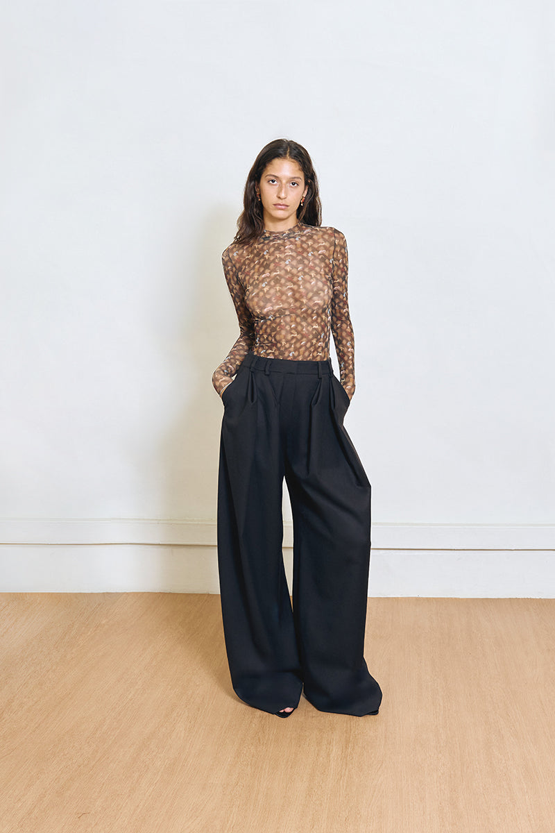 YASSMIN SALEH black pinched pants shown from the front, featuring a fitted design and stylish silhouette.