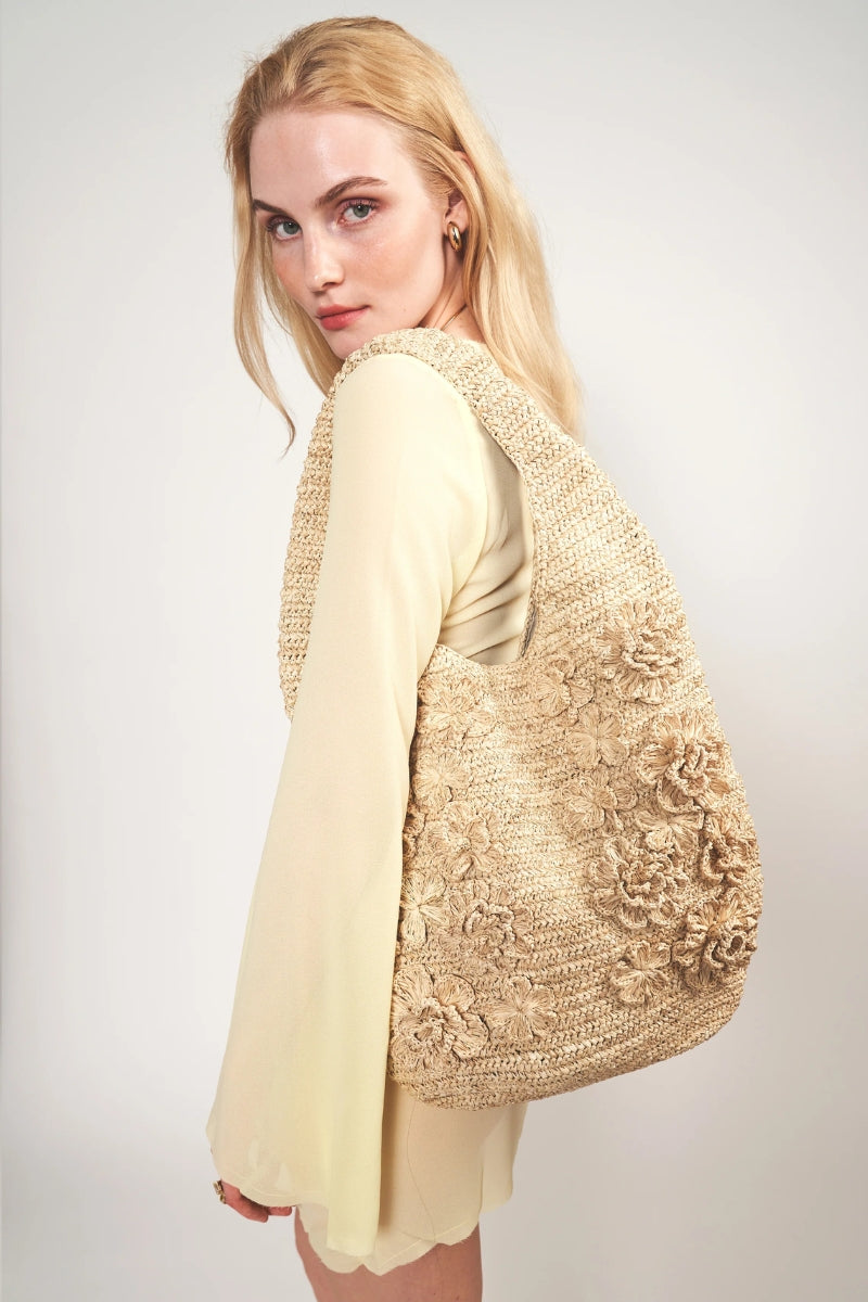 Emm Kuo Pinet shoulder bag in natural raffia with a woven design and leather strap, stylish and eco-friendly accessory.