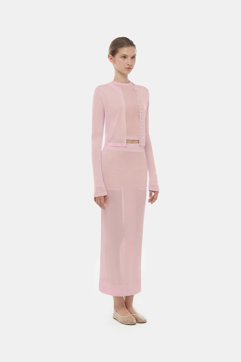 Pink button-up crop cardigan from Montsand, featuring a soft pink color and classic button details, styled as a trendy women's top.
