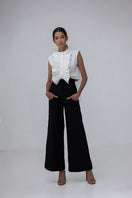 Black Pino pants by ANA + MARIA, shown on a model with a relaxed fit and high waist, featuring smooth fabric and minimalist design.