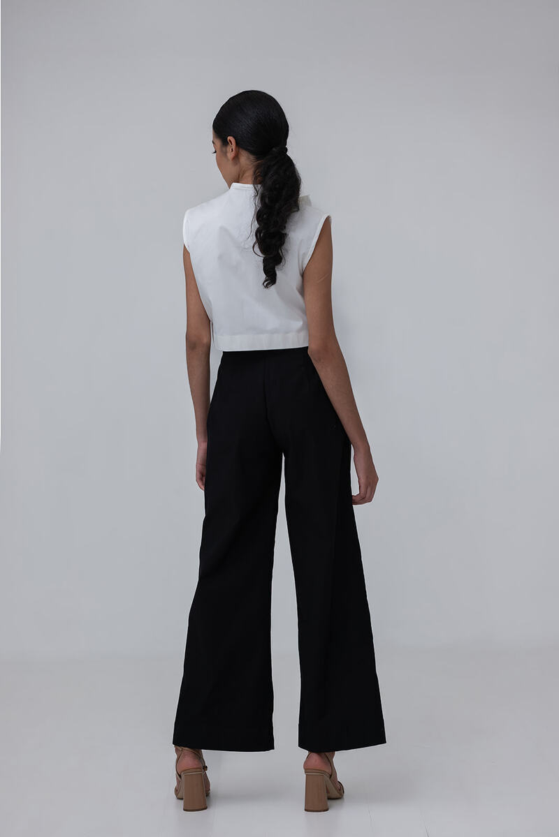Black Pino pants by ANA + MARIA, shown on a model, featuring a relaxed fit and stylish design.