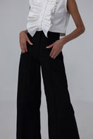 Black Pino Pants by ANA + MARIA displayed on a web model, showcasing slim fit and stylish design.