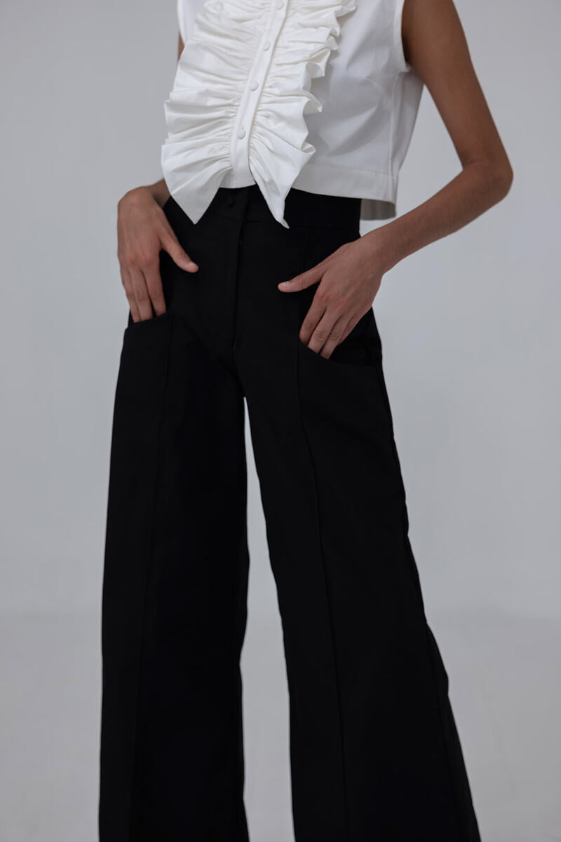 Black Pino Pants by ANA + MARIA displayed on a web model, showcasing slim fit and stylish design.
