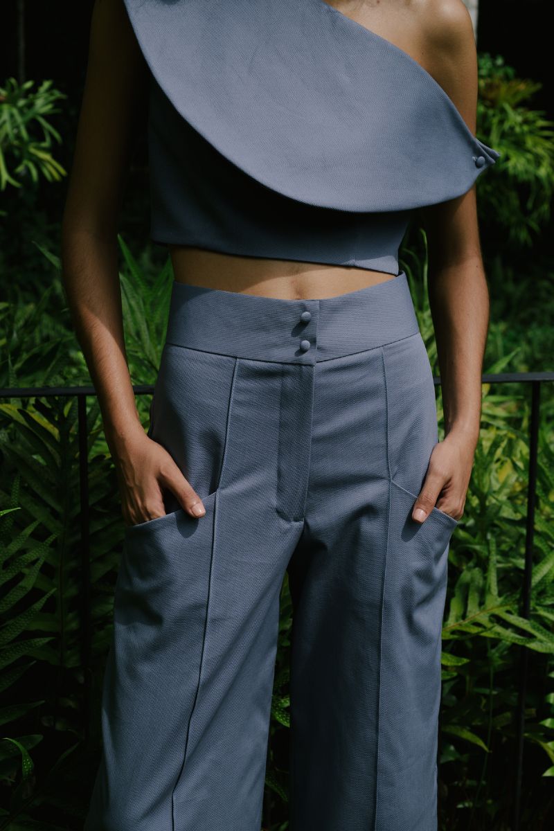 Light gray Pino pants in tempest color from ANA + MARIA, shown on a model in this stylish campaign photo.