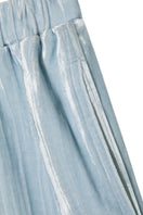 Blue velvet lounge set with pleated details, comfortable pajamas by MANITO, shown on a model in a relaxed indoor setting.