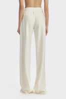 Off-white pleated trousers by Stolen Stores, stylish pants with a relaxed fit and pleated design, shown in the image.