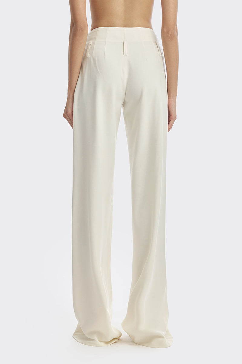 Off-white pleated trousers by Stolen Stores, stylish pants with a relaxed fit and pleated design, shown in the image.