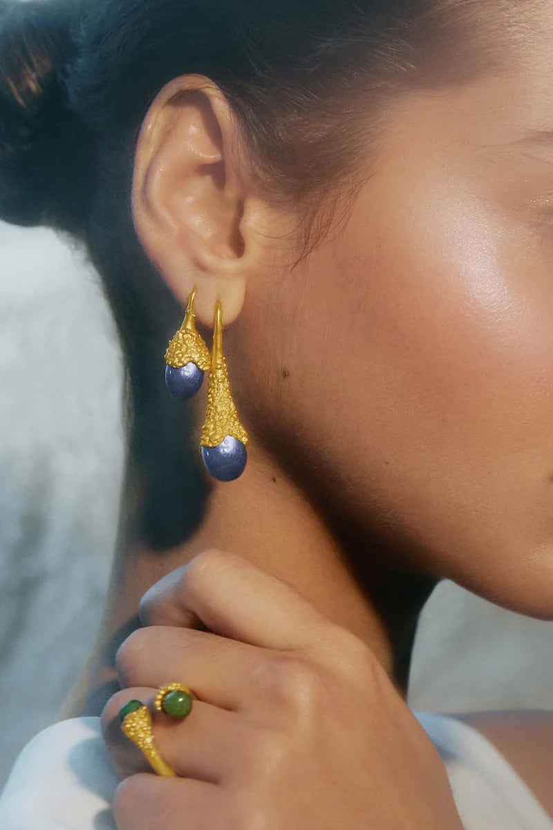 Blue plunge earrings by Jude Benhalim featuring gold accents, displayed on a white background with a sleek, modern design.