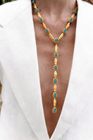 Gold and blue Jude Benhalim Poise Necklace featuring a delicate chain and elegant pendant design.