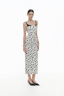 Montsand polka dot draped midi dress featuring a flowing silhouette and classic pattern, perfect for stylish occasions.
