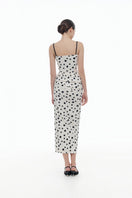 Montsand polka dot draped midi dress displayed on a hanger, showcasing its elegant flowy fabric and classic pattern.