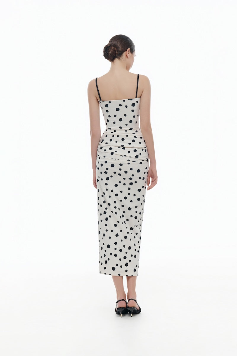 Montsand polka dot draped midi dress displayed on a hanger, showcasing its elegant flowy fabric and classic pattern.