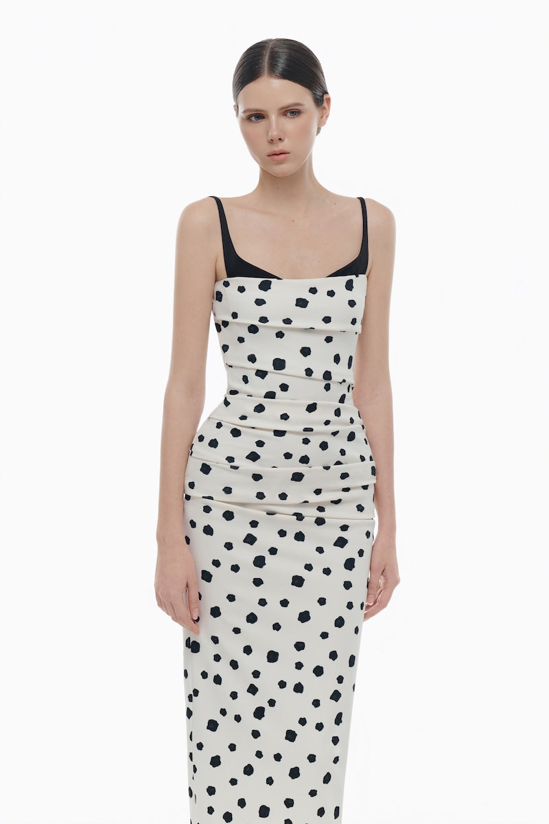 Montsand polka dot draped midi dress shown on a model, featuring flowy fabric and classic black and white polka dot pattern.