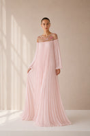 Light pink Pollen dress by Nihan Peker, elegant gown with flowing fabric and intricate detailing, displayed on a dress form.