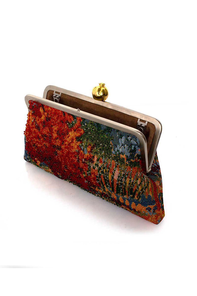 Multicolor pomegranate on autumn field classic clutch bag by Sarah's Bag, featuring vibrant fruit and fall landscape design.