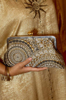 Sarah's Bag clutch featuring a pomegranate design on sunburst brocade fabric with metallic accents.