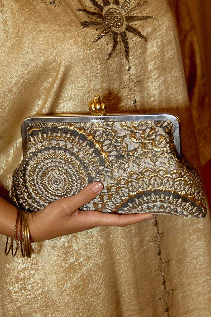 Sarah's Bag clutch featuring a pomegranate design on sunburst brocade fabric with metallic accents.