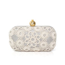 Silver Sarah's Bag clutch with a crochet pomegranate design on a sleek silver box-shaped purse.