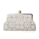 Silver clutch bag featuring a pomegranate design with crochet accents from Sarah's Bag, elegant and stylish accessory.