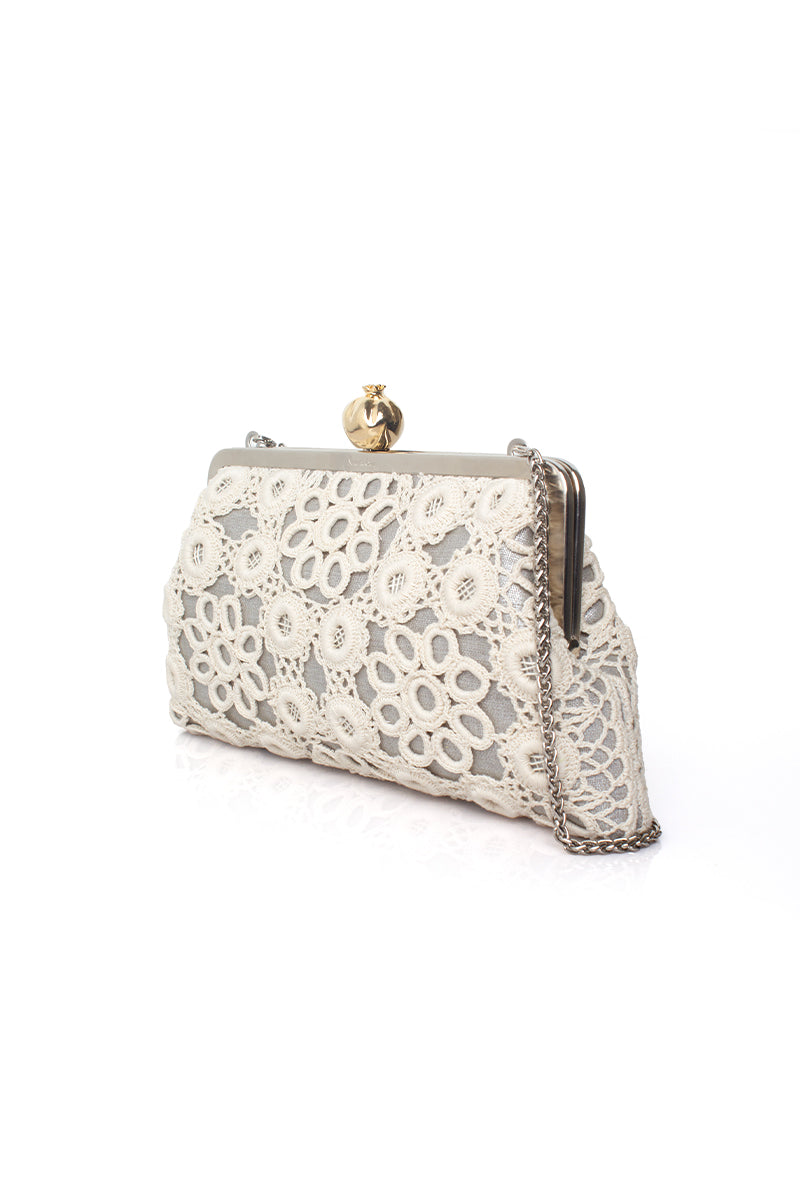 Sarah's Bag silver clutch purse featuring a pomegranate design with crochet detailing, elegant and stylish accessory.