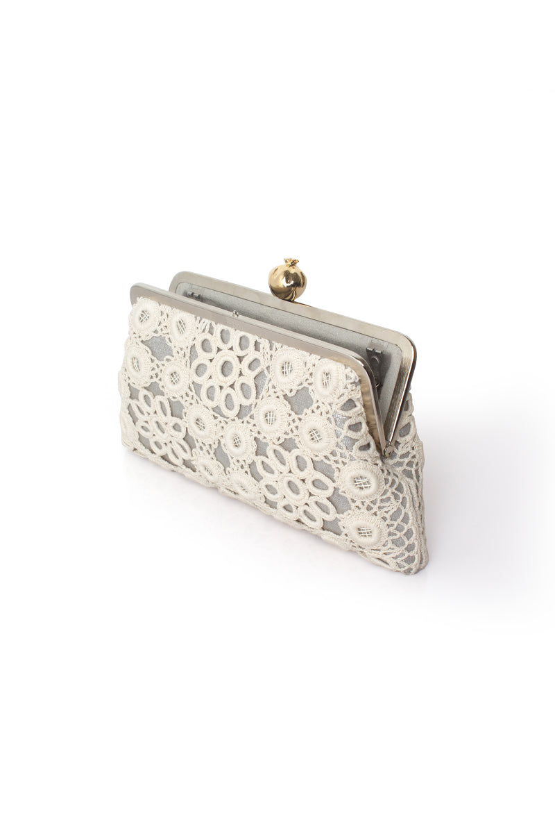 Silver clutch bag with a crochet pomegranate design by Sarah's Bag, featuring a sleek, elegant style for special occasions.