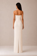 Nihan Peker vanilla poudre dress displayed on a hanger, showcasing its elegant, flowing gown design in soft fabric.
