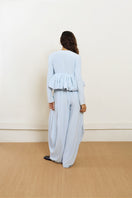 Blue YASSMIN SALEH pouf jacket displayed from the front, showcasing its stylish design and vibrant color.