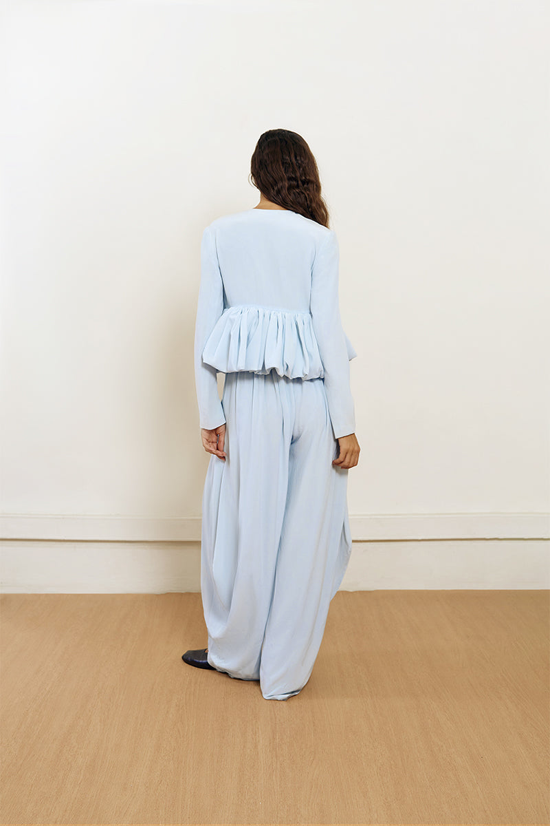 Blue YASSMIN SALEH pouf jacket displayed from the front, showcasing its stylish design and vibrant color.