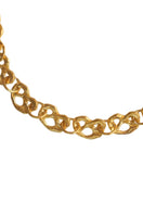 Gold pretzel-shaped mini chain necklace by Oz Objects, showcasing a delicate and stylish jewelry piece.