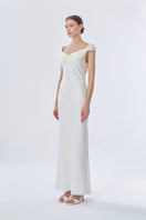 White Princess maxi slip dress by Stolen Stores, featuring a sleek, elegant design with a smooth fabric and front detail.