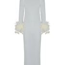 White Junie Immy Maxi Dress displayed on a hanger, showcasing its flowing fabric and elegant design.