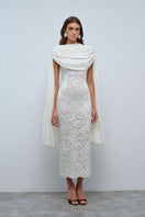 Nana Gotti Zafira midi dress displayed on a model, featuring a flowing design and stylish silhouette.
