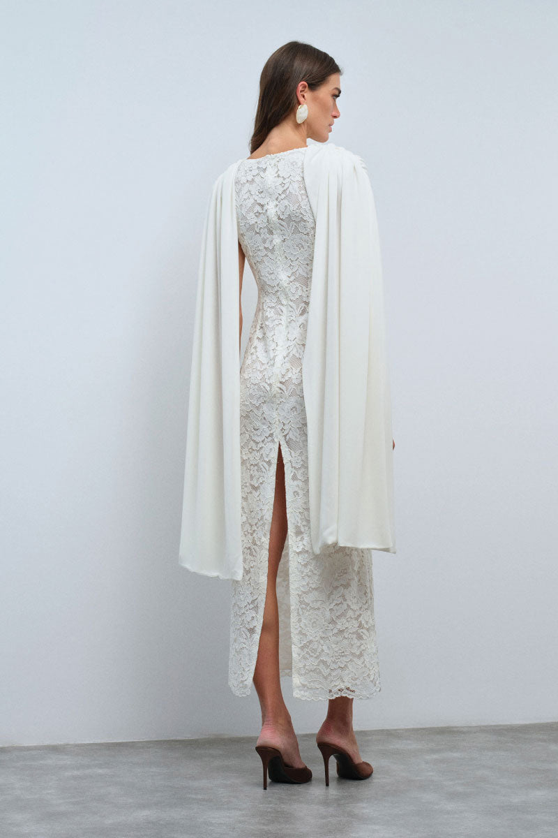 Nana Gotti ZAFIRA midi dress displayed on a hanger with floral patterns and flowing fabric, suitable for casual or semi-formal wear.