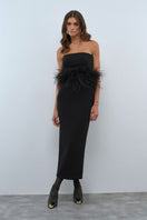 Nana Gotti VELA maxi dress featuring flowing fabric and elegant design, displayed on a hanger against a plain background.