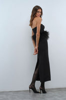 Nana Gotti VELA maxi dress in flowing fabric with a fitted bodice and elegant skirt, displayed on a hanger.