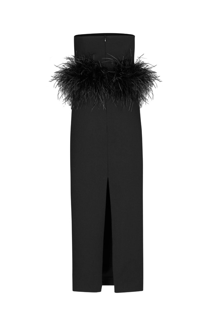 Nana Gotti Vela Maxi Dress displayed on a hanger, featuring flowing fabric and elegant design in a natural setting.