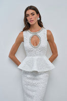 Nana Gotti KALINA maxi dress with flowing fabric and floral pattern, displayed on a hanger against a neutral background.